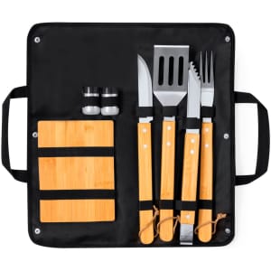A barbecue set featuring stainless steel utensils with bamboo handles, a cutting board, and salt and pepper shakers in a black case.