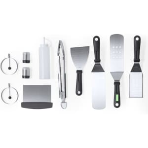 A barbecue set featuring stainless steel tongs, spatulas, sauce bottle, and seasoning containers, with black and silver details.