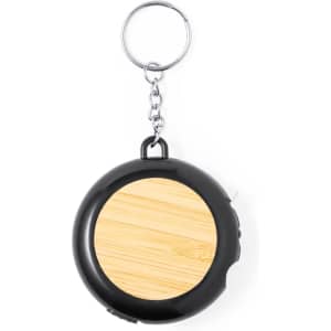 A black tape measure with a bamboo face, attached to a metal keyring.