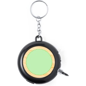 A black multitool tape measure with a keyring and wooden design element, featuring a circular section for customisation.