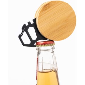 A bottle opener with a bamboo top and black metal base, positioned on a capped drink bottle.