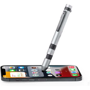 A multifunction pen in silver resting on a smartphone, showcasing its sleek design and practical features.
