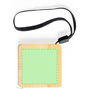 A square, green tape measure with a wooden finish, attached to a black strap. It has a logo on the surface.