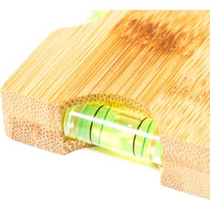 A bamboo keyring features a built-in spirit level, showcasing shades of green and natural wood colour. Includes a branding logo.