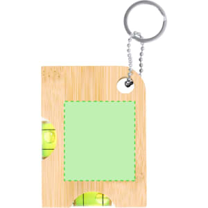 A bamboo keyring with a level tool and green blank space. It has a metal chain and keyring attachment.