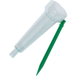 A transparent rain meter with a green stake for measuring rainfall.