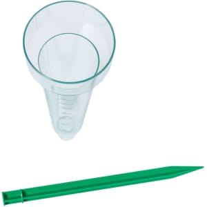 A clear rain gauge with measurement markings and a green ground stake for outdoor use.
