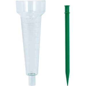 Transparent rain gauge and green stake for outdoor use. The gauge features measurement markings for rainfall collection.