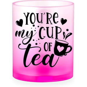A pink ombre coffee mug featuring a black design with a heart and text saying "You're my cup of tea."