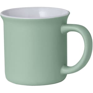 A coffee mug with a matte green exterior and a white interior, featuring a curved handle and a simple design.