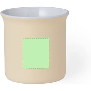 A beige coffee mug with a glossy white interior and a blank square section, featuring a logo.