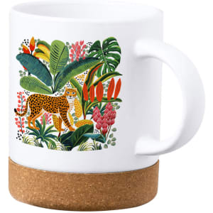 A white mug with a colourful leopard and tropical foliage design, featuring a cork base.