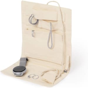A beige jewellery wrap featuring compartments for earrings, necklaces, and a watch. It includes a logo.