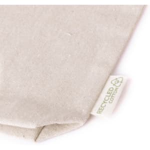 A beige toiletry bag made from recycled cotton, featuring a small tag indicating the material.