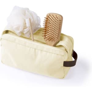 A yellow toiletry bag featuring a wooden hairbrush, a loofah, and a toothbrush. The bag has a logo.