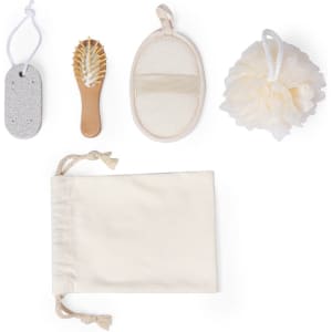 A beige storage pouch containing a wooden hairbrush, a loofah, a pumice stone, and a body scrubber.