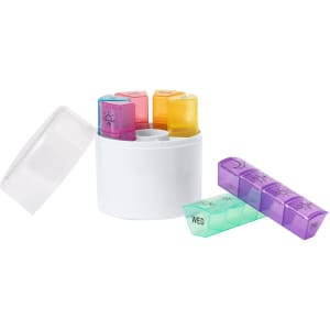 A circular white pillbox with colour-coded compartments for each day of the week, featuring a clear lid.