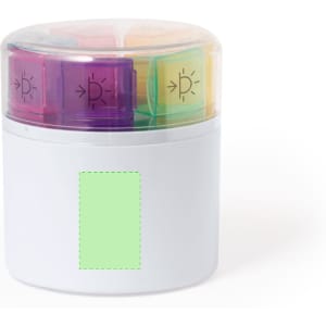 A white pillbox with a transparent lid and colourful compartments in purple, yellow, and green. Features a logo.