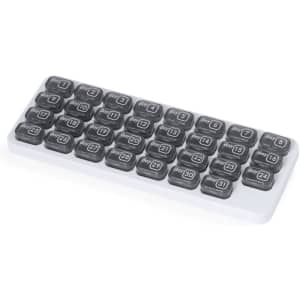A white pillbox with grey compartments labelled from day 1 to day 31, designed for organising medication.