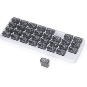 A grey and white pillbox featuring 31 compartments labelled for each day of the month, with a logo present.