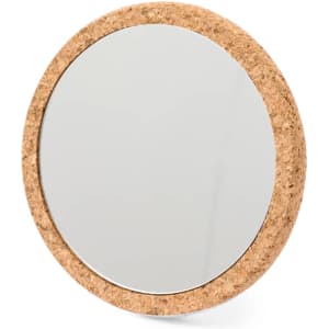 A round pocket mirror with a cork edge, featuring a reflective surface and a natural, earthy appearance.