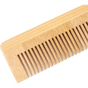 A wooden comb in a light natural colour with narrow and wide teeth, featuring a smooth surface.