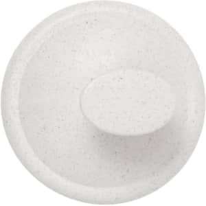 A round, speckled white lid for a container, featuring a central knob, on a plain background.