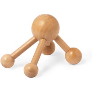 A wooden massager with a spherical top and three rounded legs, designed for health and personal care.