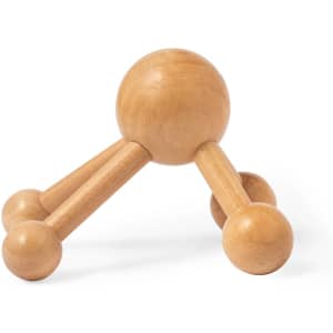 A wooden Avati Massager in a natural finish, featuring multiple rounded knobs for massage points and a sturdy base.