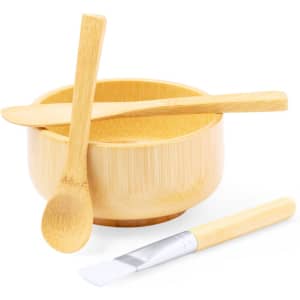 A bamboo bowl set featuring a smooth bowl, a spoon, and a spatula, all in a natural finish.