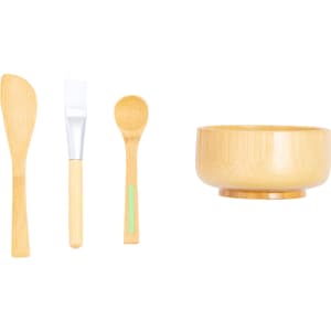 A bamboo facial mask set featuring a mixing bowl, spatula, and spoon in natural wood tones.