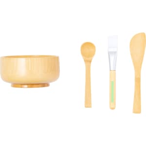 A bamboo bowl with a smooth finish accompanied by a spoon, spatula, and applicator brush in coordinating bamboo design.