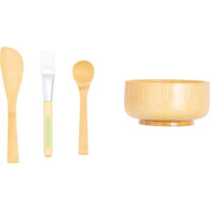A bamboo facial mask application set including a bowl, spatula, and spoon in natural wood tones.