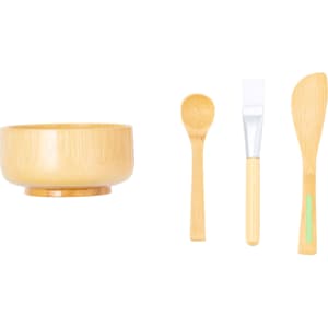 A bamboo bowl and three utensils, including a spoon, spatula, and a mixing stick, all in natural wood tones.