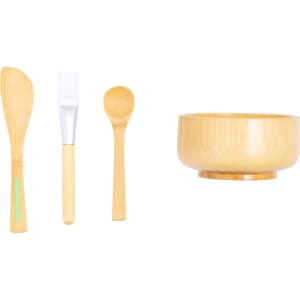 A bamboo bowl and three utensils: a spoon, a spatula, and a brush, all featuring natural wood tones.