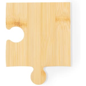 A bamboo coaster in a puzzle piece shape, featuring a natural wood finish and a simple design.