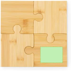 A bamboo coaster set featuring a puzzle piece design with a green blank section. It has a natural, warm colour.