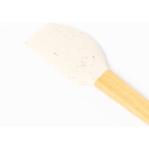 A silicone spatula with a white head and a bamboo handle, featuring a smooth surface and rounded edges.