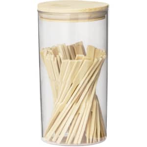 A clear container filled with wooden chopsticks, topped with a bamboo lid. Suitable for home dining.