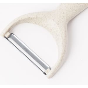 A cream-coloured vegetable peeler with a stainless steel blade and a textured handle. It has a minimalistic design.