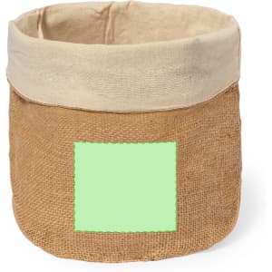 A jute bread basket with a natural beige linen top and a blank green label on the front. It features a rustic design.