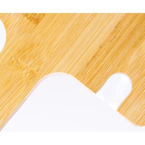 A bamboo and white cutting board featuring rounded edges and a hanging hole for easy storage.