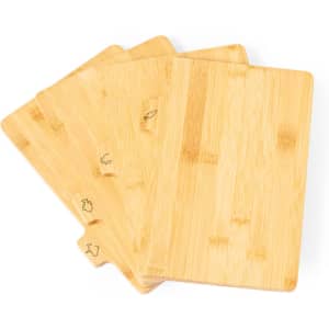 A set of four bamboo cutting boards featuring different engraved designs, with a natural wood finish.