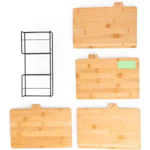 A bamboo cutting board set in natural colour with a black metal rack, featuring four boards of varying sizes.