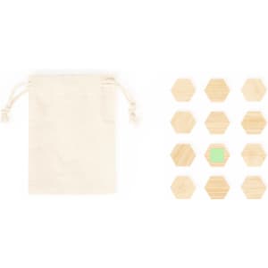 A beige drawstring bag alongside a set of wooden hexagonal magnets in natural wood tones, with one green magnet.