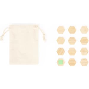 A natural fabric pouch beside a set of wooden hexagonal magnets in various shades, including one green.