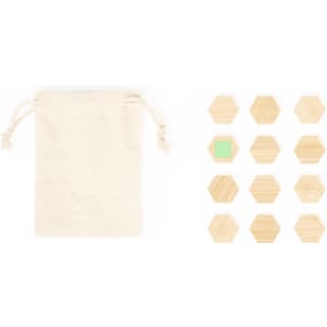 A beige drawstring bag alongside hexagonal wooden magnets, featuring a light green magnet among the natural wood finish.