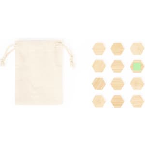 A cotton pouch alongside a set of wooden hexagonal magnets in various natural hues, including one green.