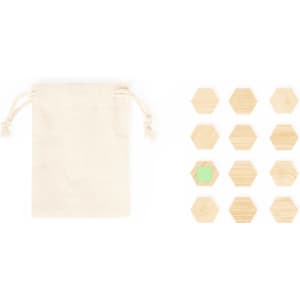 A natural cotton pouch next to a set of wooden hexagon magnets in various shades, including one with a green centre.
