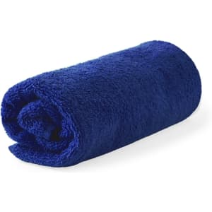 A rolled navy blue hand towel, soft and fluffy, featuring a brand logo.